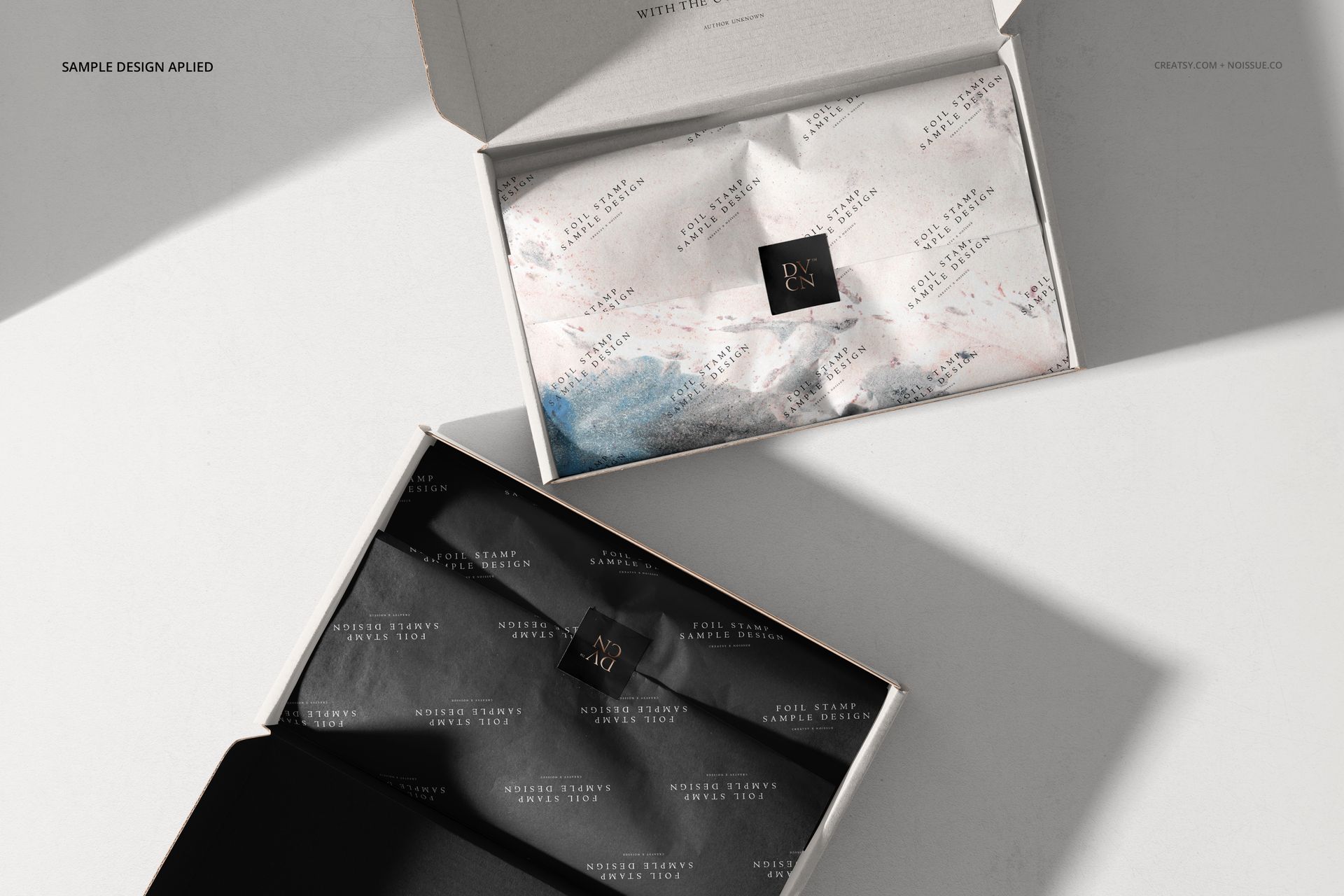 Open mailing boxes mockup showing interior details, including folded tissue paper in contrasting black and white designs.