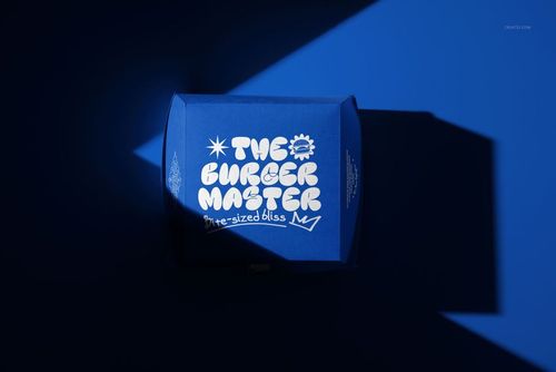 Burger box mockup with vibrant blue color and stylized white logo, illuminated by angled light and shadow.