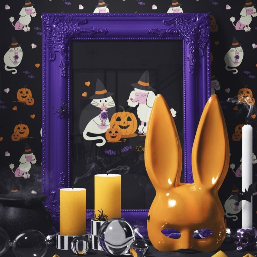 Halloween picture frame mockup featuring a purple ornate frame with animal art, surrounded by candles and festive decor.