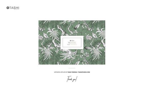 Green patterned fabric with white and gray birds and floral elements displayed on a rustic farmhouse bench mockup.