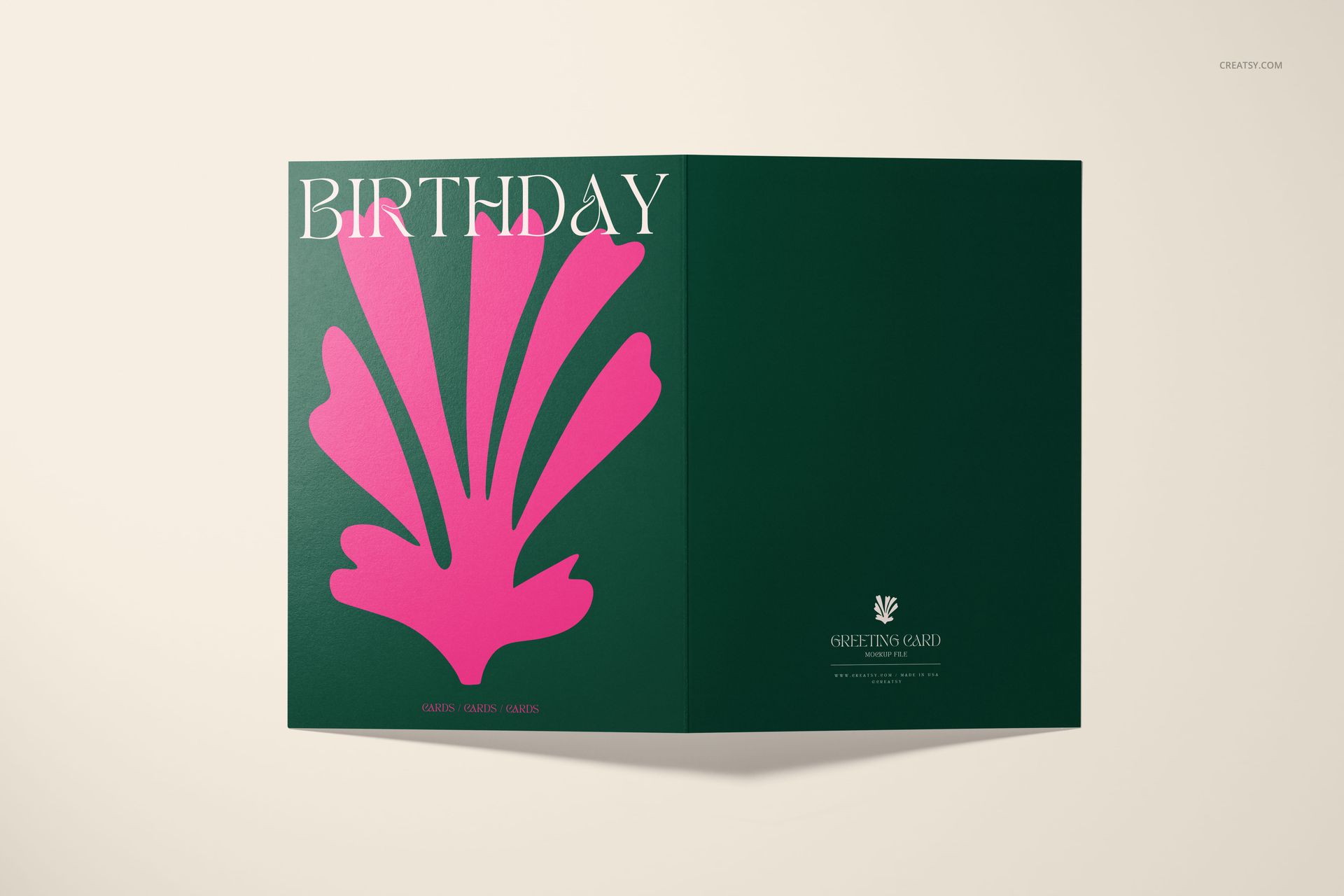 Front view of a 5x7 greeting card mockup with dark green cover, large pink abstract shape, and white text.