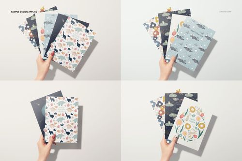 Greeting cards mockup set showing a woman's hand holding cards with playful animal and flower designs, top-down perspective.