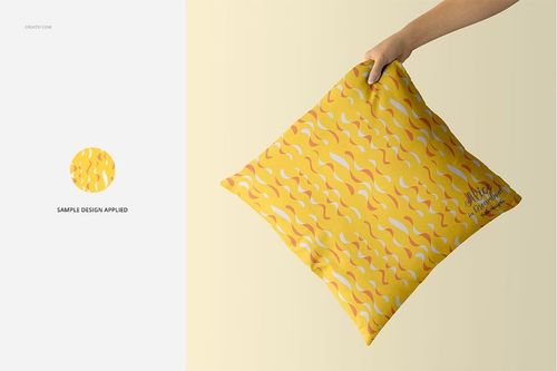 PSD mockup of a square pillow with a yellow surface and abstract orange and white wave pattern, shown in hand.