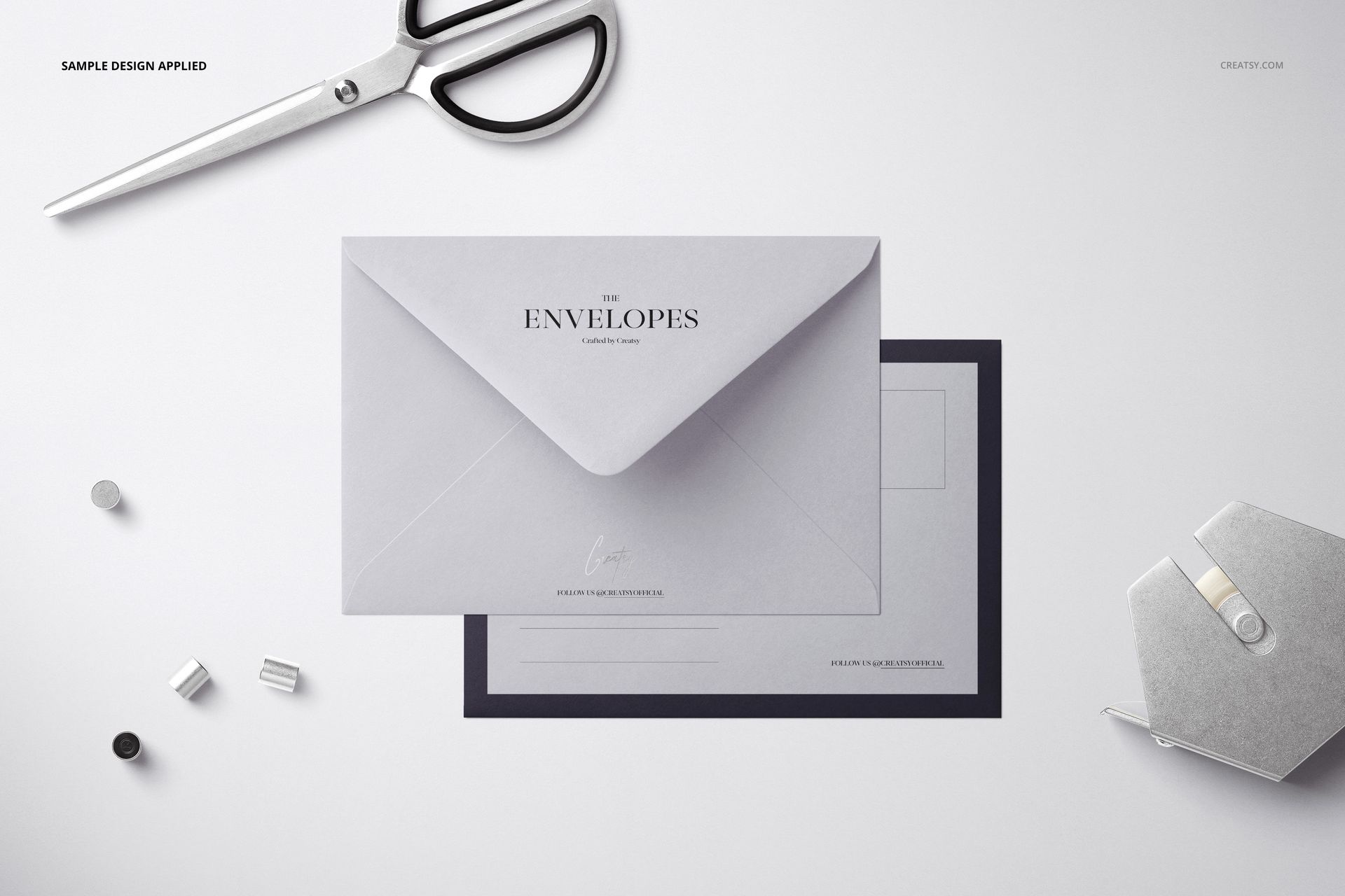 C6 envelope mockup displayed from a top view, featuring a light gray envelope with stationery items nearby.