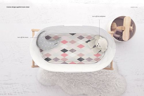 Bassinet liner mockup featuring a soft diamond pattern in pastel colors, shown inside a wooden bassinet from above.