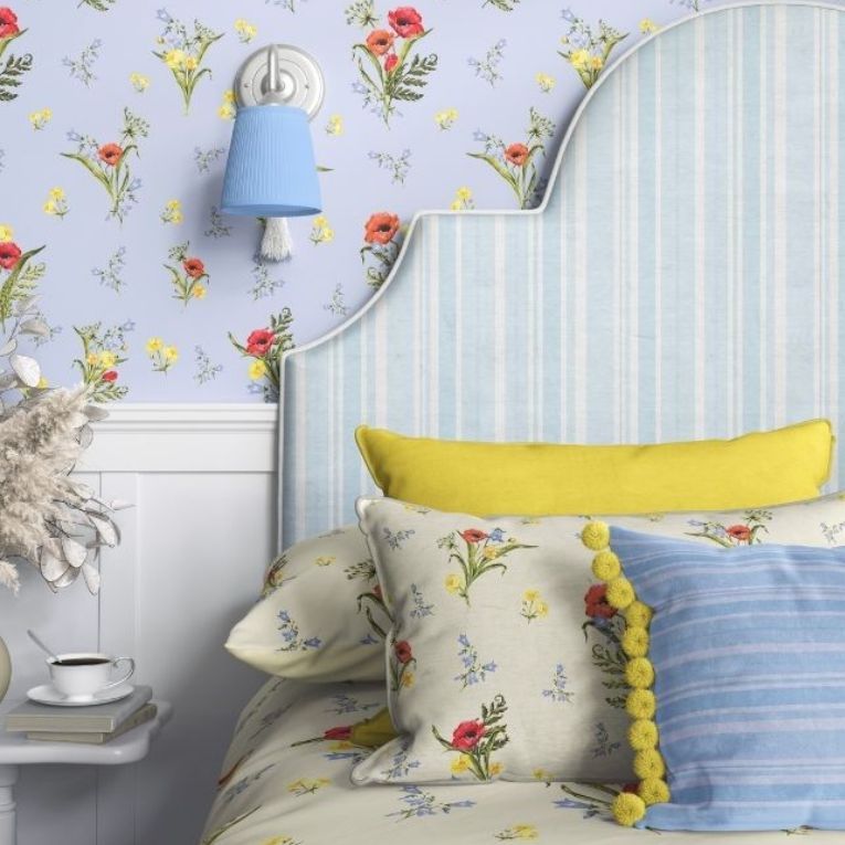 Bedroom pillows, a striped headboard, and floral wallpaper mockup with pastel colors and a blue wall lamp in a cozy setting.