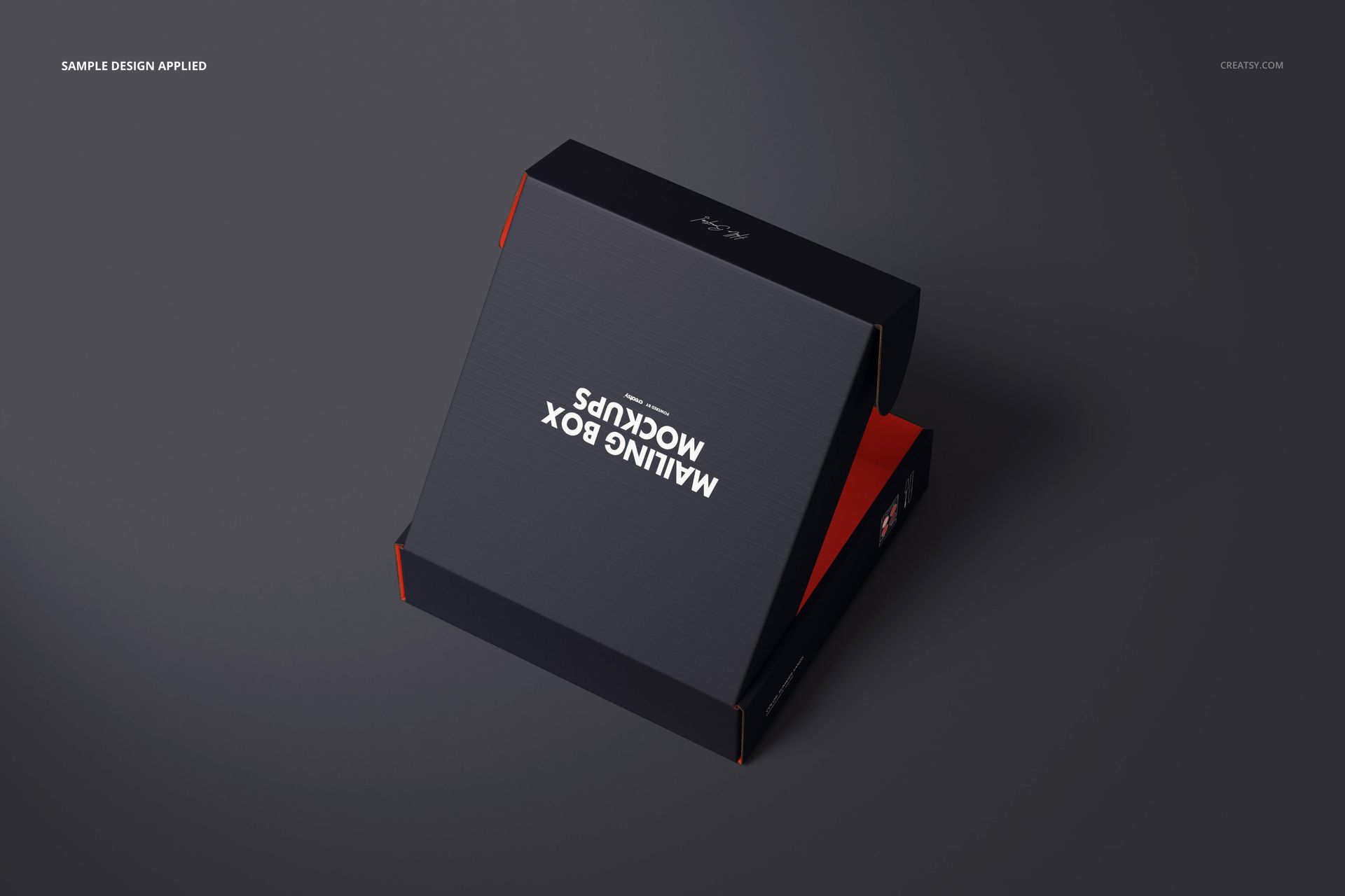 Rectangular mailing box mockup with dark textured surface, partially open, viewed from an angled top perspective.