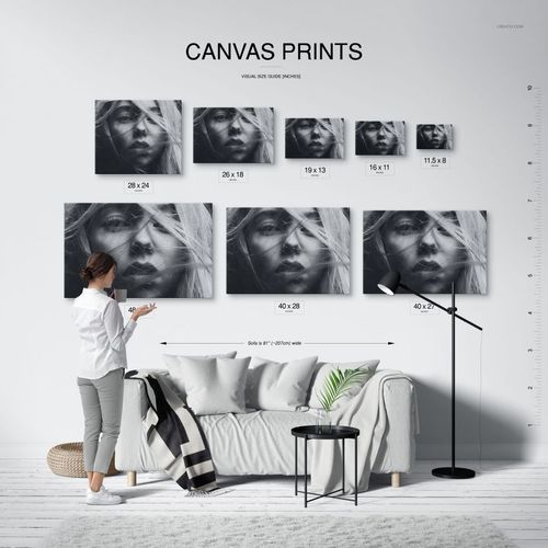 Canvas print size comparison mockup showing different sized canvases arranged above a sofa in a minimalist interior.