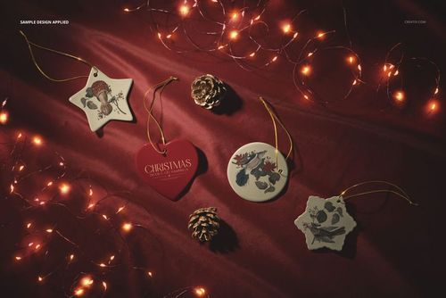 PSD mockup featuring star, heart, round, and snowflake-shaped ceramic ornaments on a festive red background with pinecones.