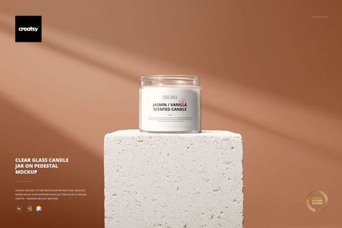 Glass candle jar mockup featuring a round transparent container with white candle, placed on a stone pedestal.
