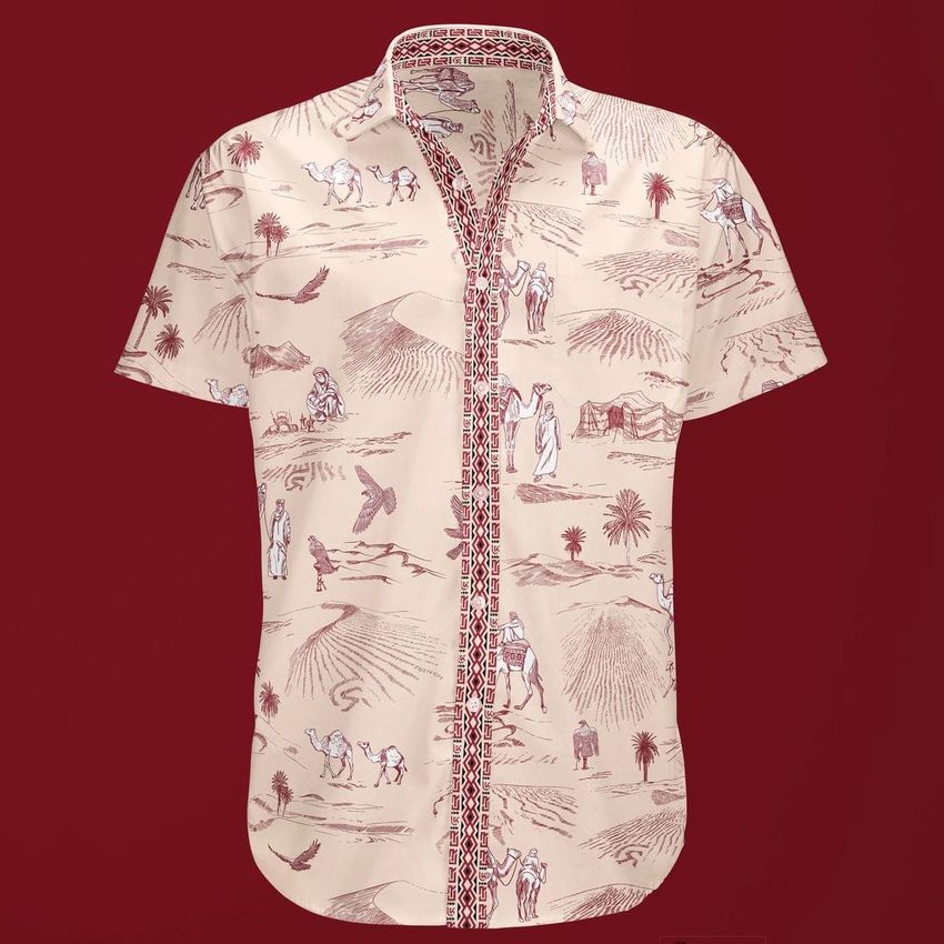 Short sleeve dress shirt mockup featuring a beige fabric with maroon desert-themed illustrations, displayed on a solid maroon background.