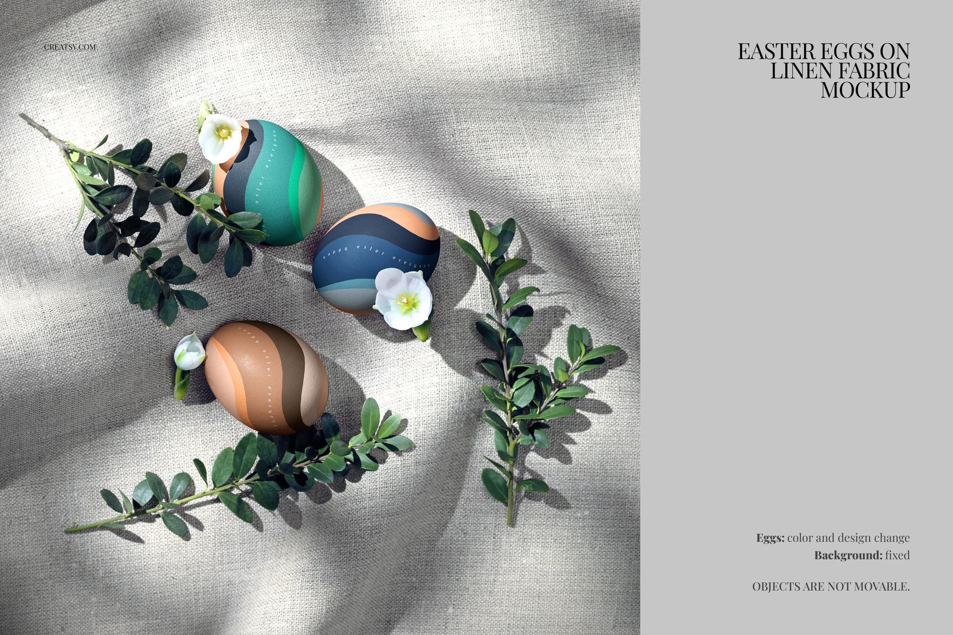 Three decorated Easter eggs on linen fabric, surrounded by green leaves and white flowers, top view mockup.