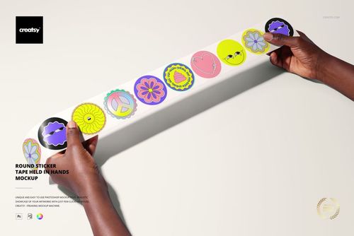 Hands holding a long strip of round stickers with playful patterns, shown in a realistic stationery mockup scene.