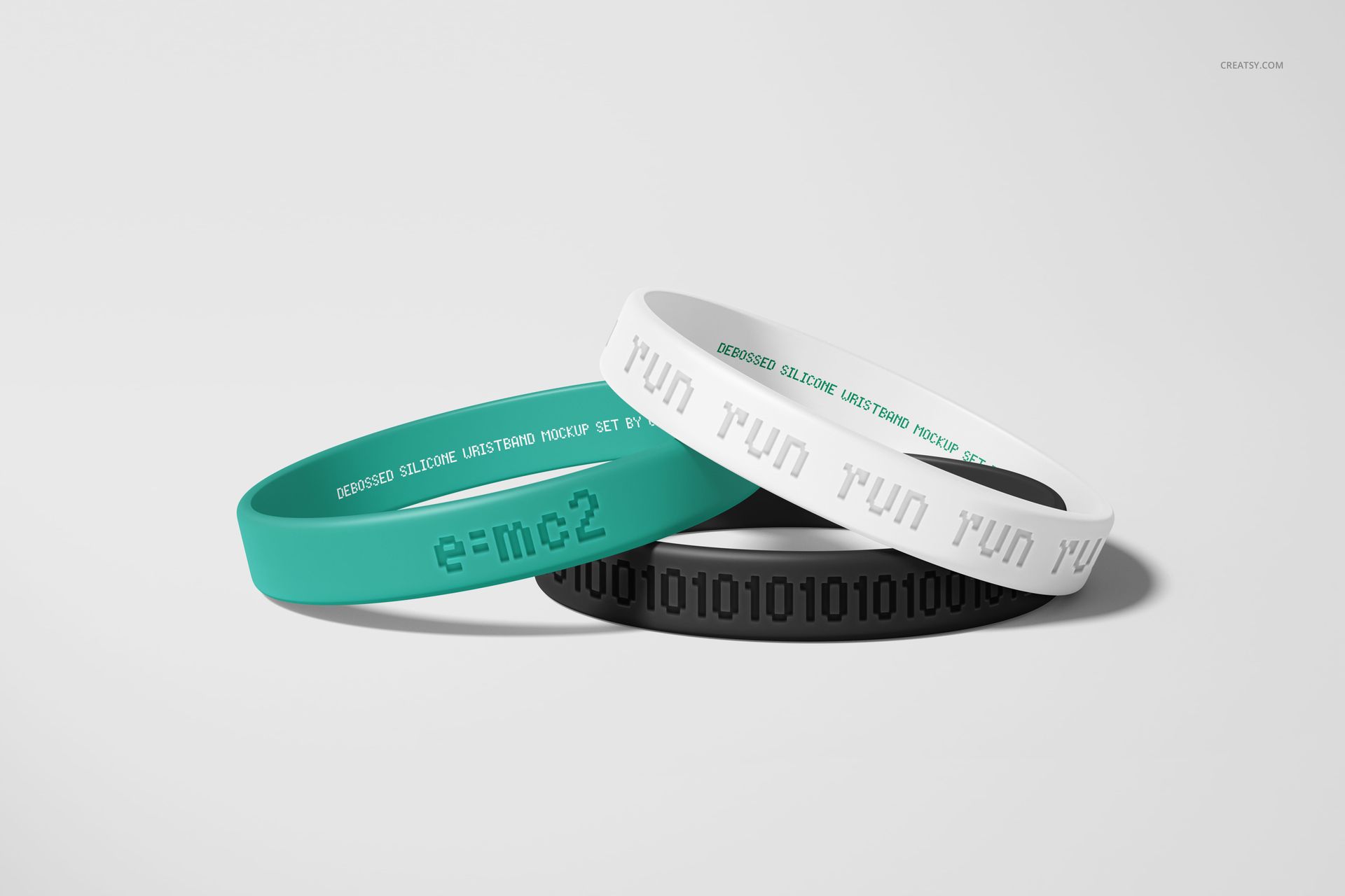 Stacked silicone wristbands mockup featuring teal, white, and black bands with debossed text on a neutral background.