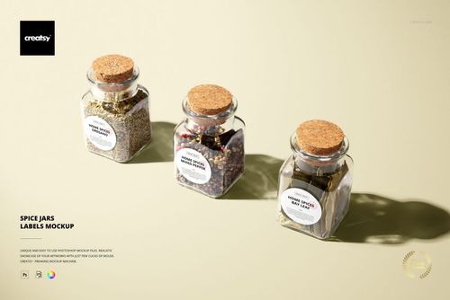 PSD mockup showing a trio of glass spice jars with cork stoppers and custom white labels, illuminated by soft light.