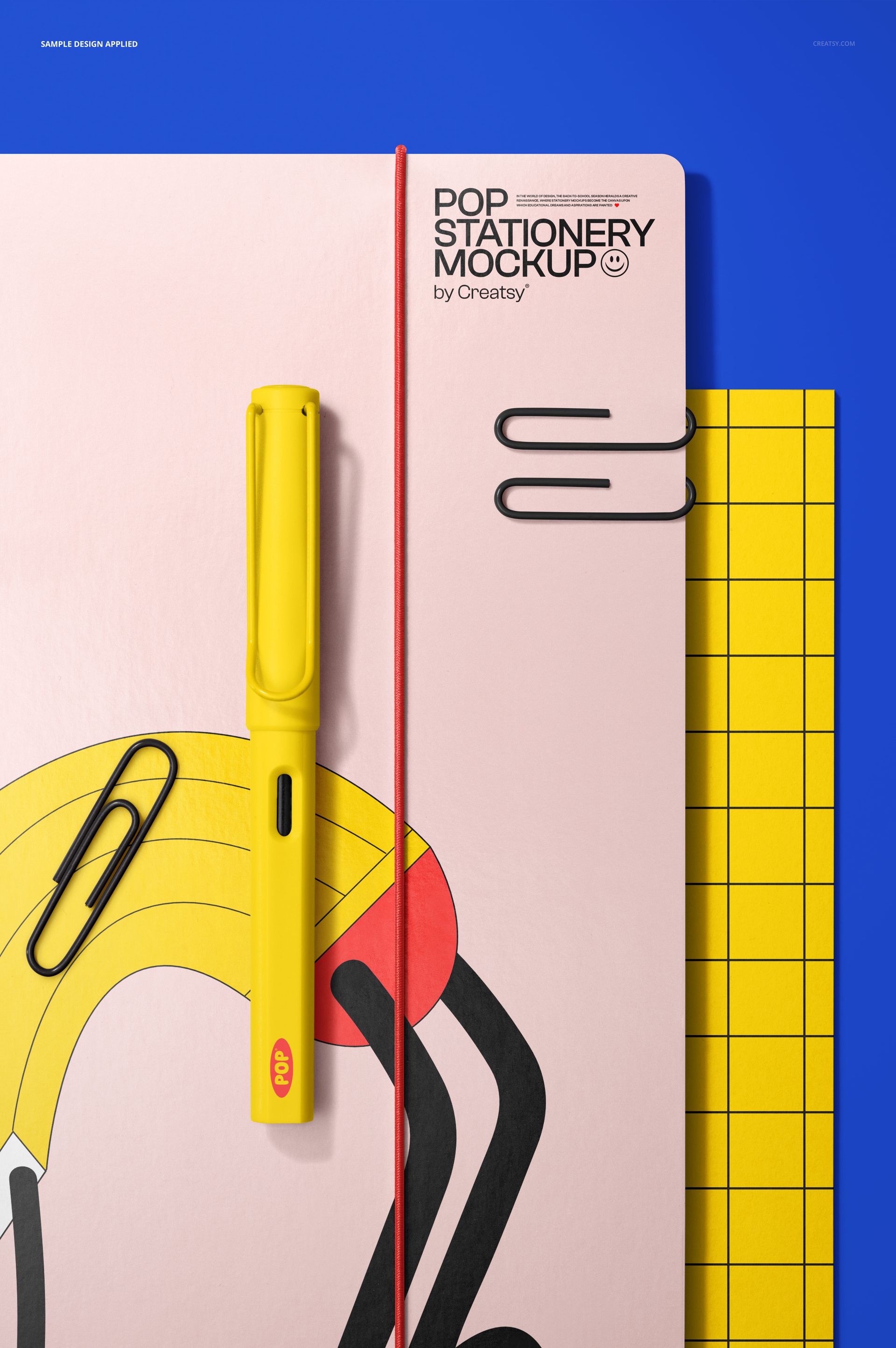 Close-up view of a paper folder mockup with a yellow pen, paper clips, and a red elastic band on a blue background.