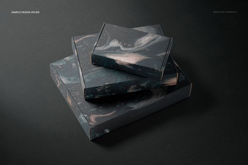 PSD mockup featuring a set of rectangular packaging boxes with swirling black and gray design, displayed at an angle.