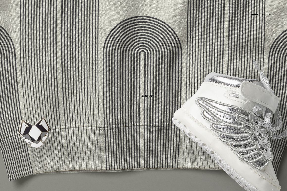 Heather baby sweatshirt mockup featuring vertical black stripes and a silver shoe with wing design in close-up.