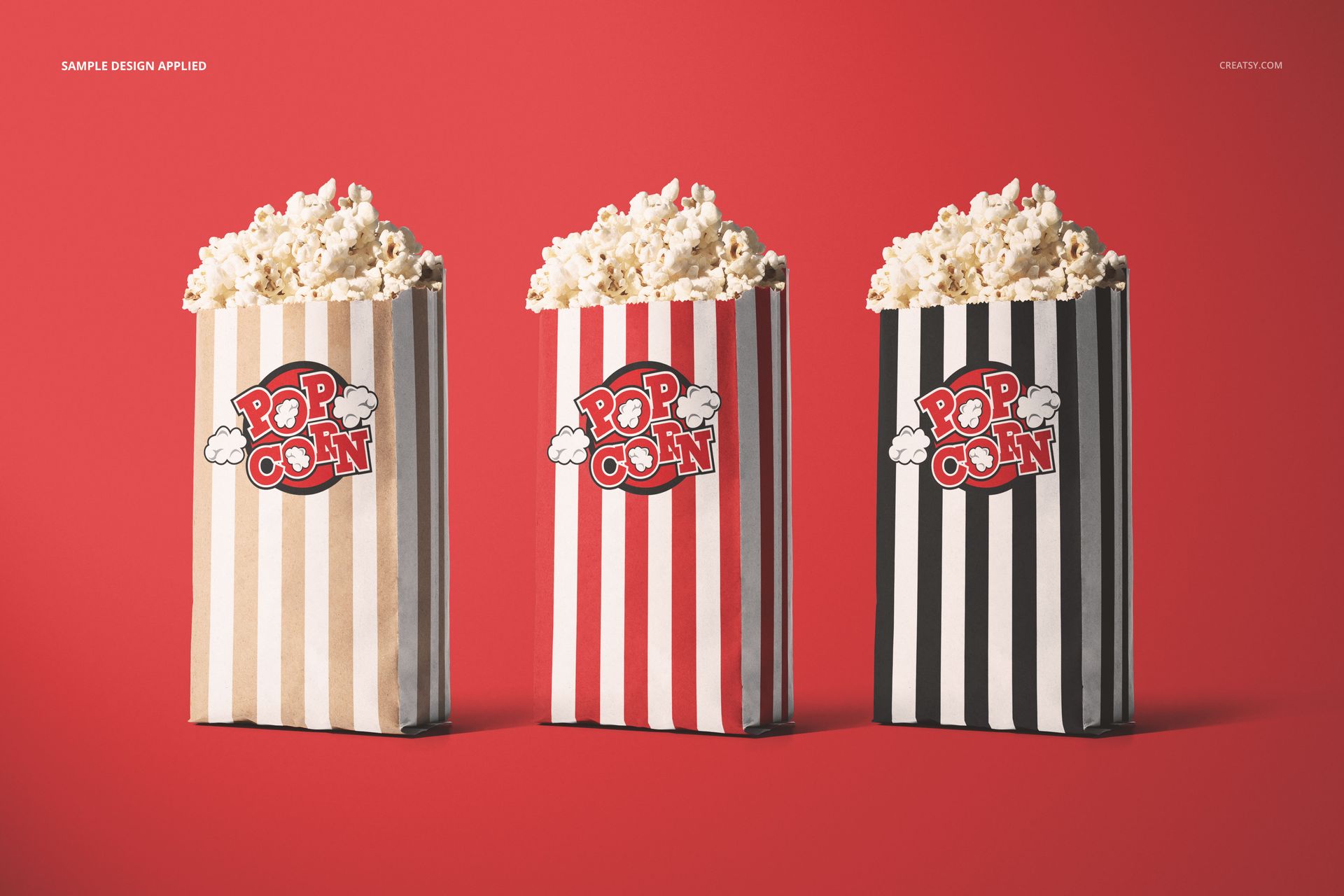 Popcorn paper bag PSD mockup featuring three striped bags in different colors, filled with popcorn on a red surface.