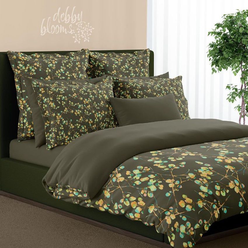 Bedding mockup featuring a bed with green and yellow botanical patterned duvet and pillows in a modern bedroom setting.