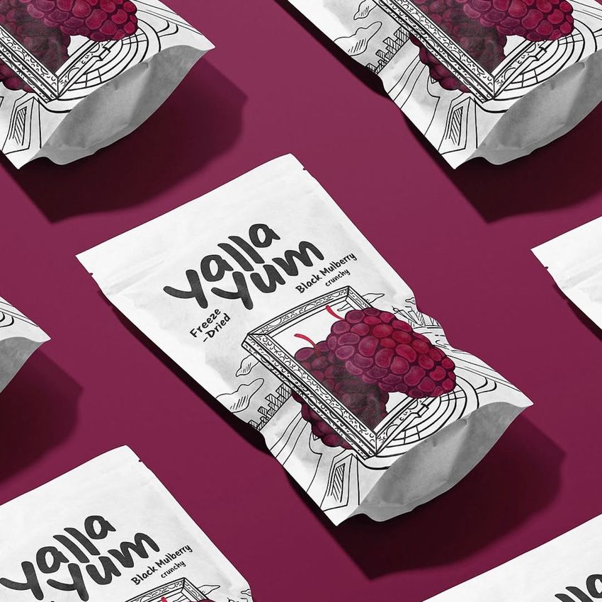 Stand up paper pouch mockup featuring multiple white pouches with illustrated mulberry fruit and bold text, arranged on a burgundy surface.