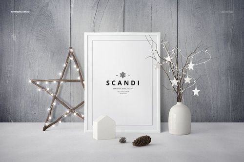 Framed square print mockup on a gray wooden wall, with a lit star decoration, white vase with branches, and pinecones.