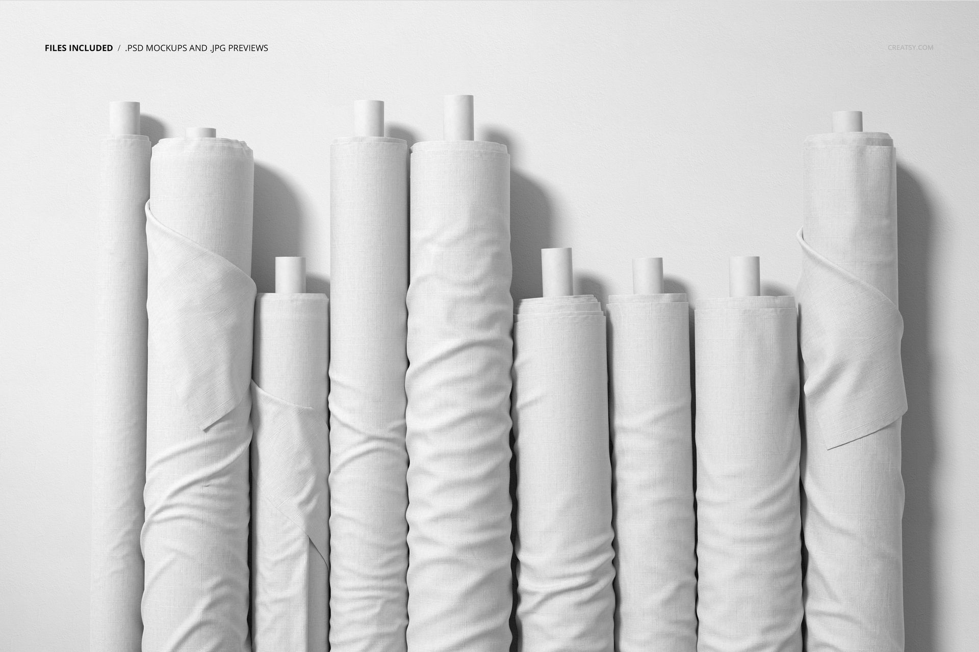 Fabric rolls mockup featuring a group of plain white textiles on cardboard tubes, displayed upright in a minimal setting.