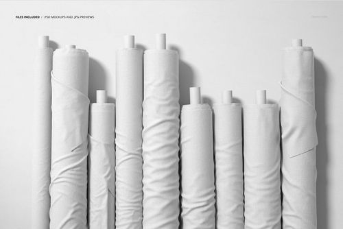Fabric rolls mockup featuring a group of plain white textiles on cardboard tubes, displayed upright in a minimal setting.