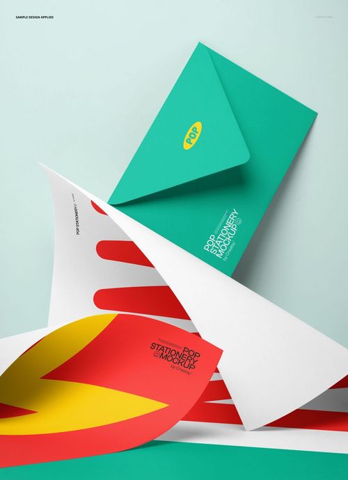 Stationery mockup featuring two colorful posters with geometric designs and a teal envelope arranged on a flat surface.