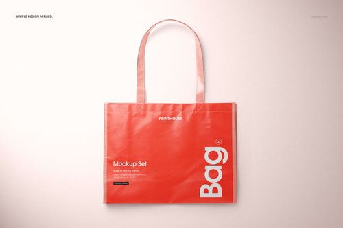 Red laminated tote bag mockup with long handles, white lettering, and a subtle shadow on a pale background.