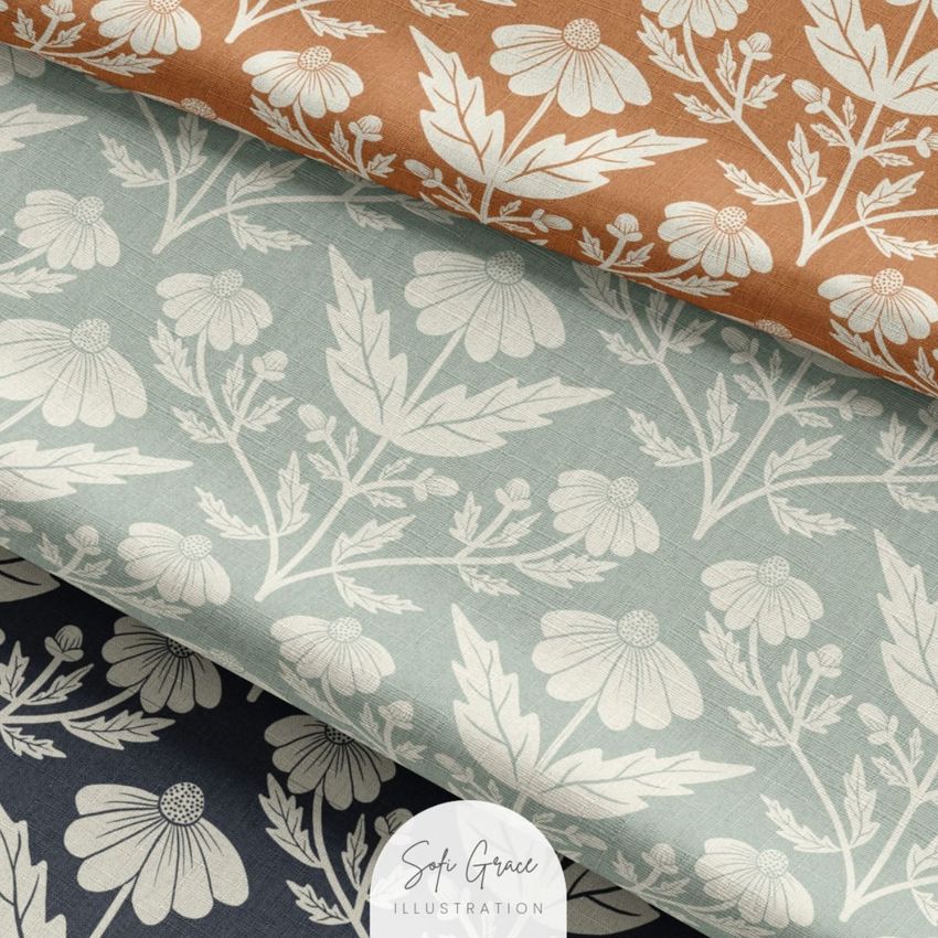 Fabric mockup showing three layered textile swatches with daisy and leaf patterns in brown, light blue, and dark blue colors.