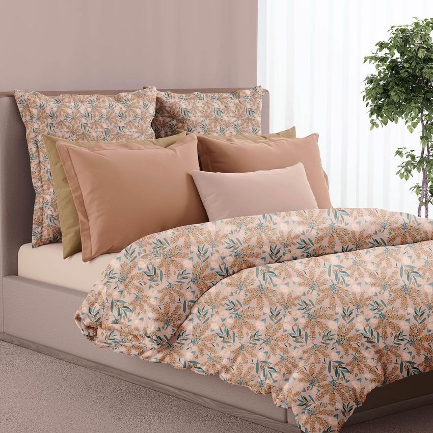 Bedroom scene bedding mockup showing a bed with floral patterned duvet and pillows in soft peach, green, and beige tones.