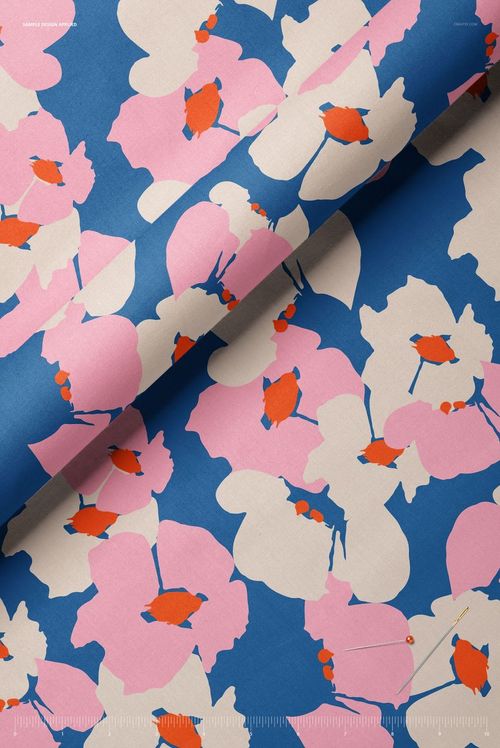 Closeup view of cotton fabric mockup featuring a bold floral pattern in pink, white, and orange on a blue background.