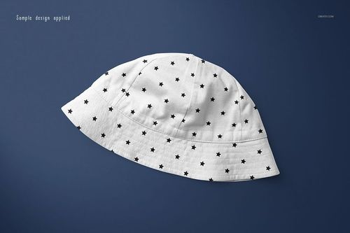 White baby hat with black star pattern displayed on a solid dark blue background in a top view mockup.