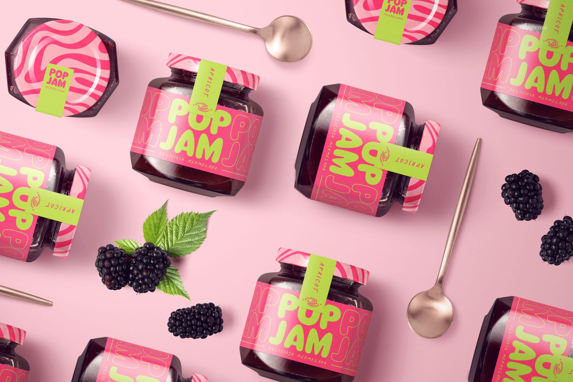 Front view of several blackberry jam jars with pink and green labels arranged on a pastel pink surface with blackberries.