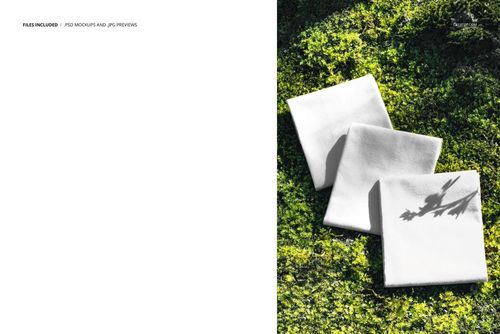 White fabric squares placed on vibrant moss, viewed from above, with sunlight casting shadows on the mockup scene.