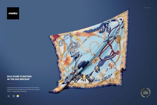 Elegant silk scarf mockup featuring intricate designs and borders, suspended in mid-air on a blue backdrop.