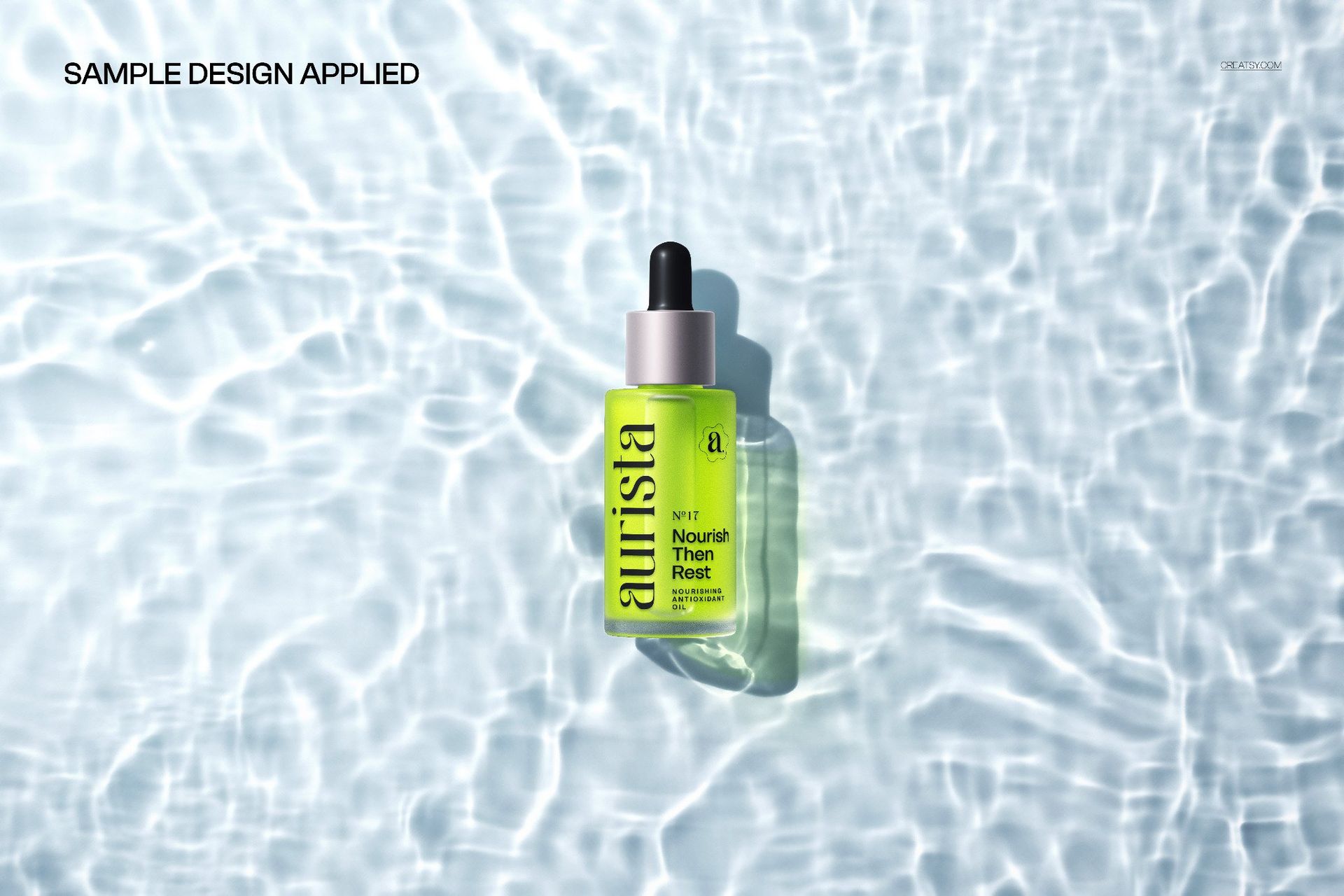 Cosmetic serum bottle mockup with black dropper cap, positioned on clear water with sunlight reflections, top view.