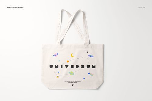 White tote bag mockup displayed on a light background, decorated with planets, stars, and playful typography.