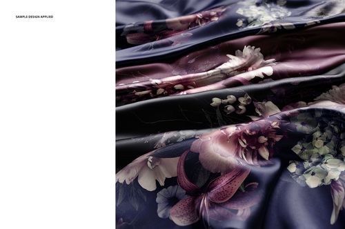 Close-up of satin fabric mockup with a smooth surface, displaying purple and cream flowers on a dark background.