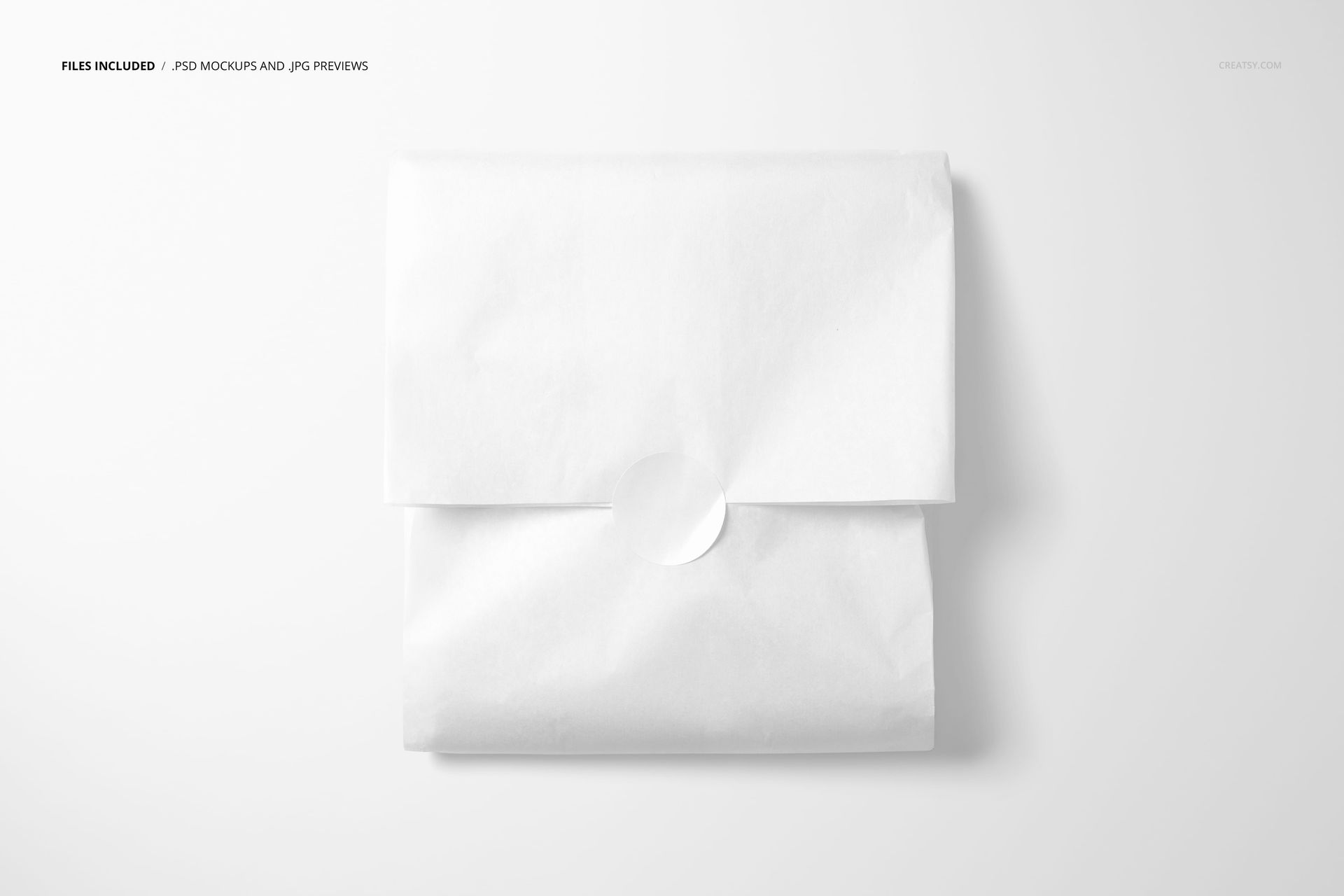 PSD mockup of a square tissue paper wrap featuring a simple white sticker, displayed on a clean background.