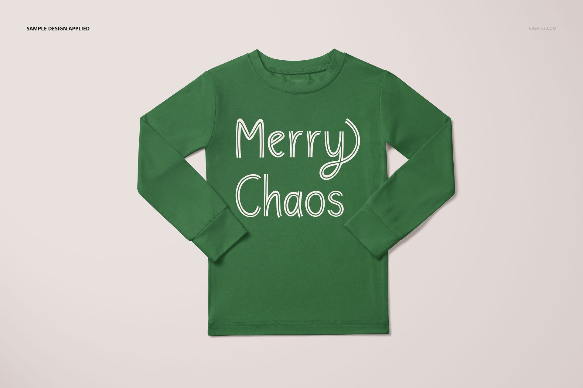 Toddler pajama mockup featuring a green shirt with white lettering, shown flat against a light neutral surface.