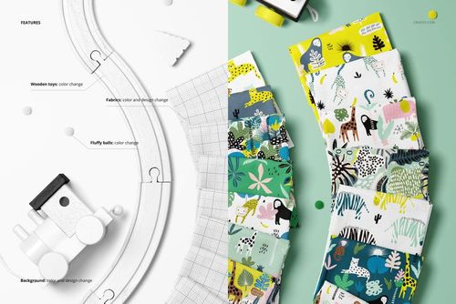 PSD mockup showing stacked cotton fabrics with whimsical patterns, set alongside curved wooden train tracks and toys.