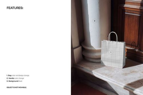 Square paper shopping bag mockup with handles placed on marble steps beside a white column in natural light.