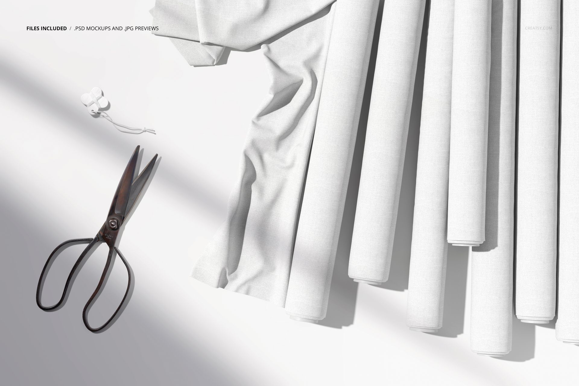 PSD mockup showing neatly aligned fabric rolls in white, with loose fabric, scissors, and earphones placed on the left side.