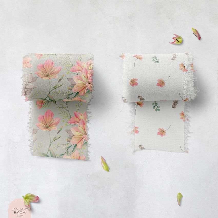 Fabric mockup showing two pieces of material with floral patterns, laid flat on a light surface with scattered flower petals.