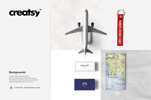 Top view of airline-themed mockup set with airplane model, business card, map, and red key tag on white background.