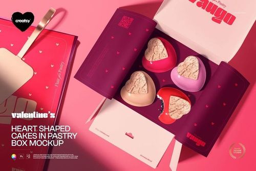 PSD mockup showing heart shaped cakes in red and pink boxes with open pastry packaging on a pink surface.