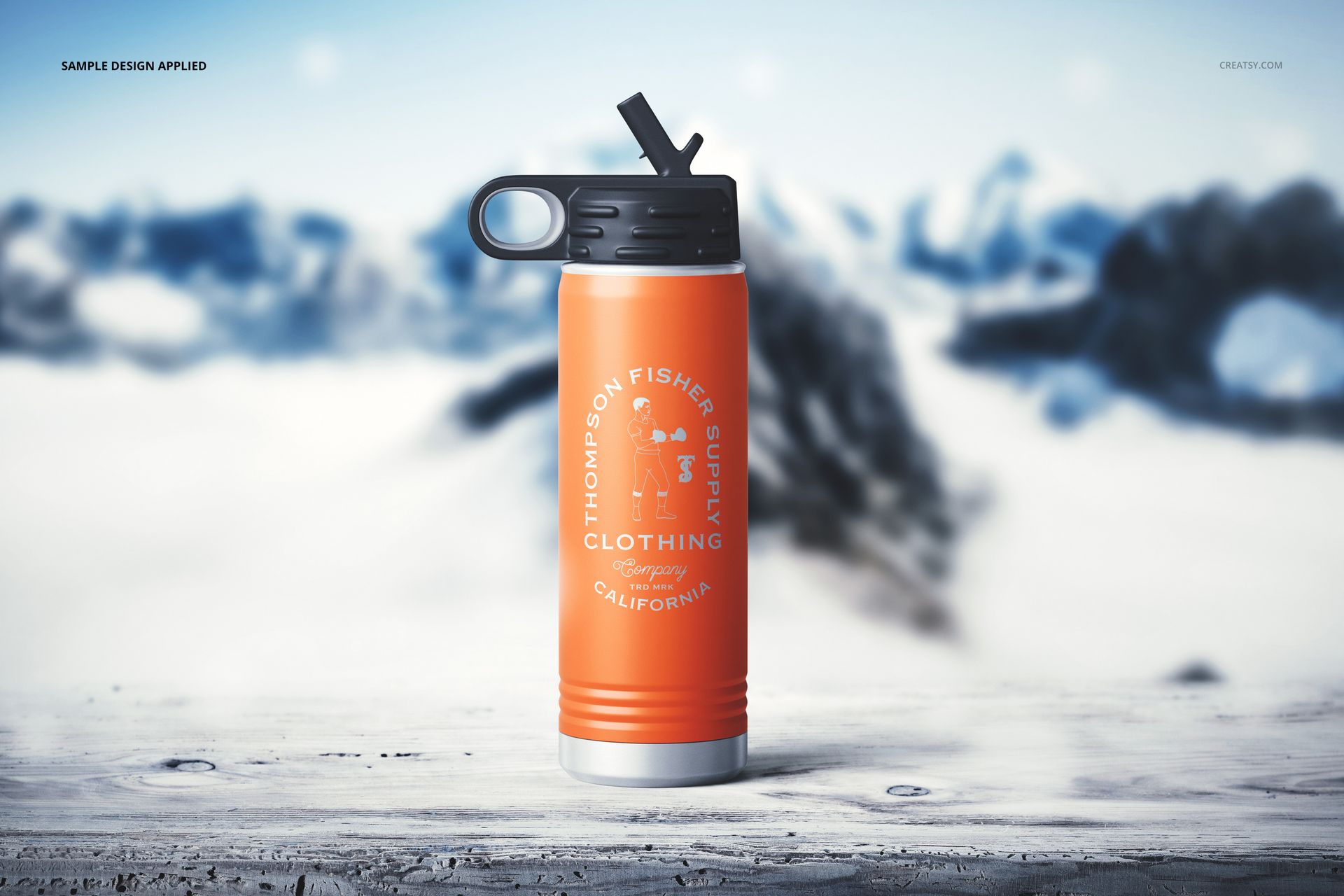 Orange powder coated water bottle mockup with black flip-top lid, white graphic, and blurred snowy mountain background.