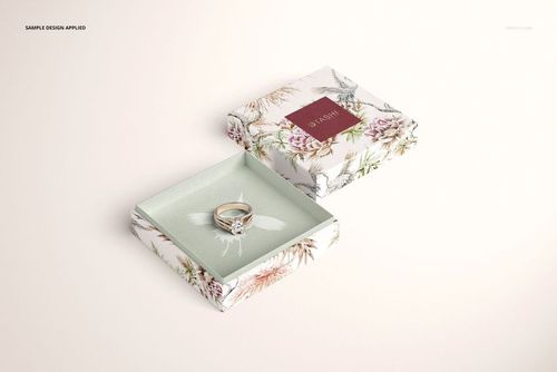 Floral jewelry box mockup displayed open, featuring a ring and decorative botanical design, viewed from above.
